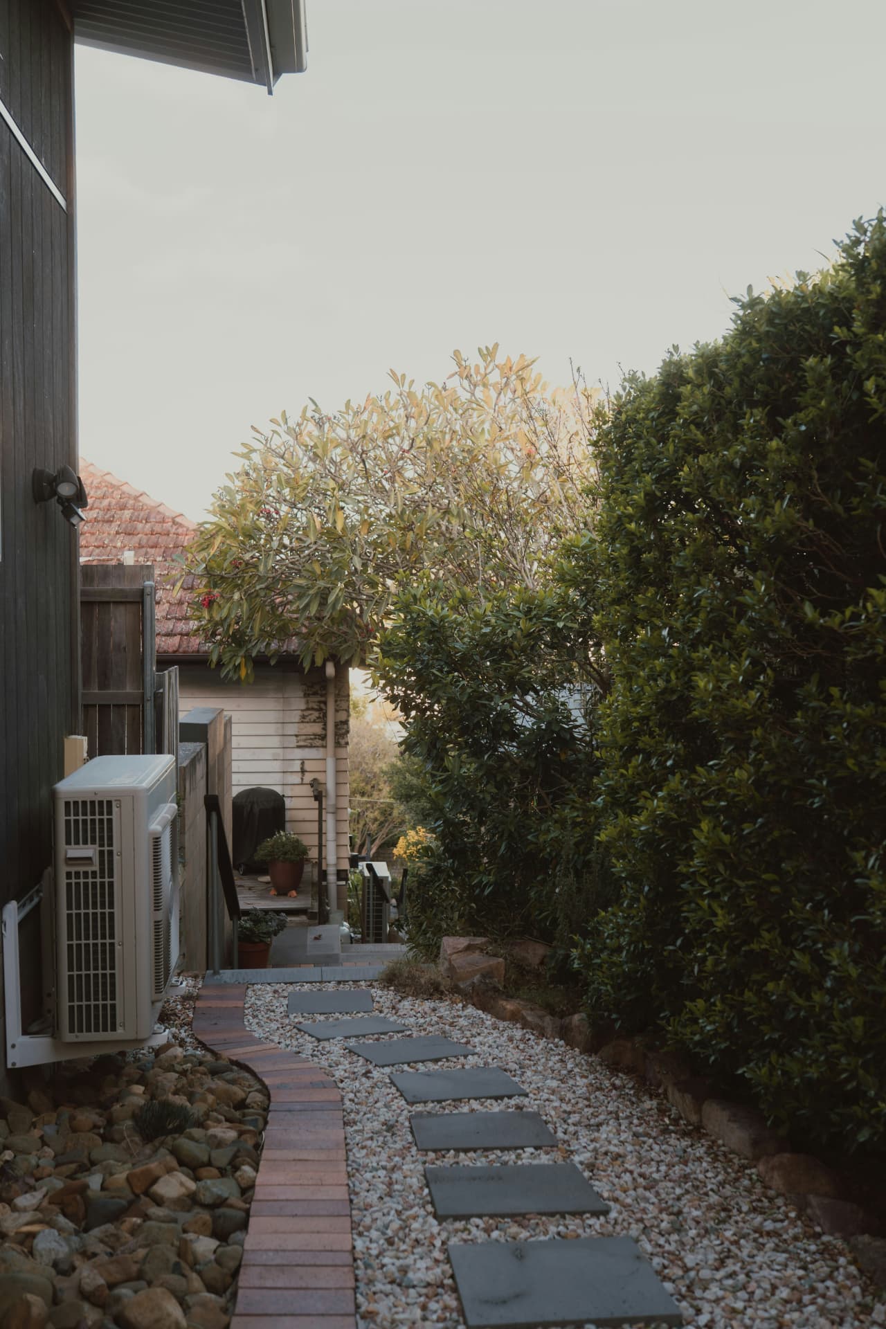 Brick-edged gravel side path with stepping stones
